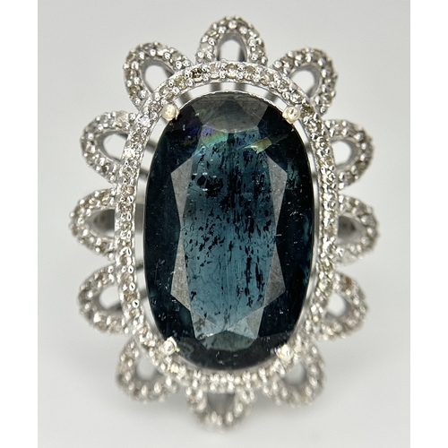 202 - A 5.6ct London Blue Topaz Ring with 1ctw of Diamond Accents. Set in 925 Silver. Size O. Comes with a... 