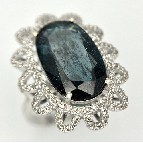 202 - A 5.6ct London Blue Topaz Ring with 1ctw of Diamond Accents. Set in 925 Silver. Size O. Comes with a... 