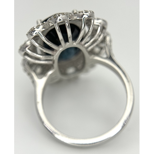 202 - A 5.6ct London Blue Topaz Ring with 1ctw of Diamond Accents. Set in 925 Silver. Size O. Comes with a... 