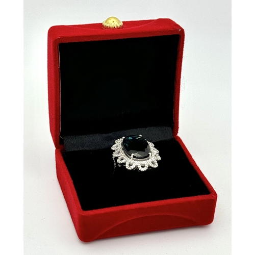 202 - A 5.6ct London Blue Topaz Ring with 1ctw of Diamond Accents. Set in 925 Silver. Size O. Comes with a... 