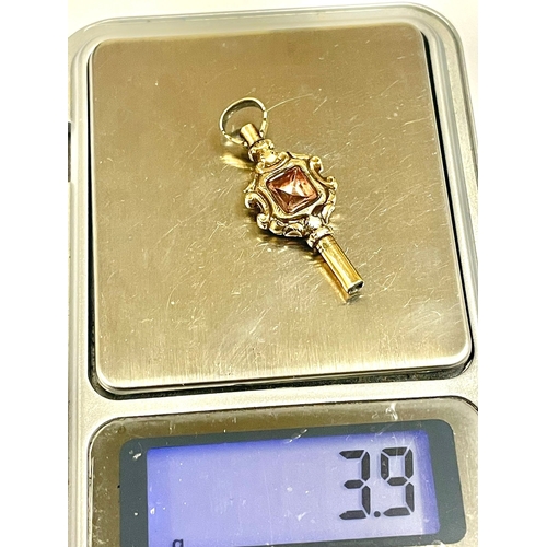 851 - A yellow metal Victorian pocket watch key with gemstone. L10