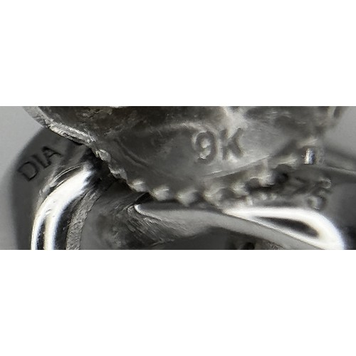 873 - A Pair of 9K White Gold Diamond Knot Stud Earrings. 1.95g.