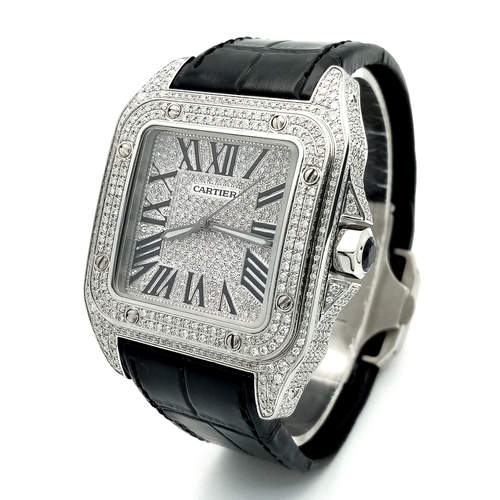 A Cartier Santos 100 Diamond Encrusted Gents Watch. Black leather strap with Cartier diamond encrusted exterior clasp. Stainless steel large diamond encrusted tank case - 51 x 38mm. Two row diamond set bezel. Diamond set dial with Roman Numeral markers. Note: All diamonds have been professionally custom fitted. Comes with a Cartier case.
