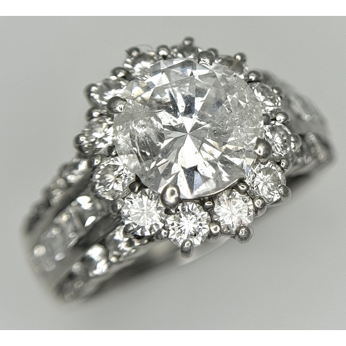 A STUNNING PLATINUM DIAMOND RING WITH A 2ctw CENTRAL DIAMOND SURROUNDED BY A FURTHER 1.6ctw OF TOP QUALITY NATURAL DIAMONDS .    9.97gms    size N