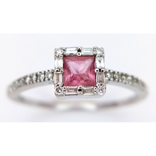 757 - An 18K White Gold, Diamond and Pink Sapphire Ring. Princess cut sapphire with baguette diamond surro... 