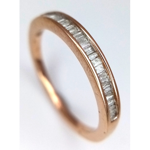 764 - A 9K Yellow Gold Diamond Half Eternity Ring. Tapered baguette channel set diamonds. Size L. 1.75g.