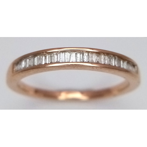 764 - A 9K Yellow Gold Diamond Half Eternity Ring. Tapered baguette channel set diamonds. Size L. 1.75g.