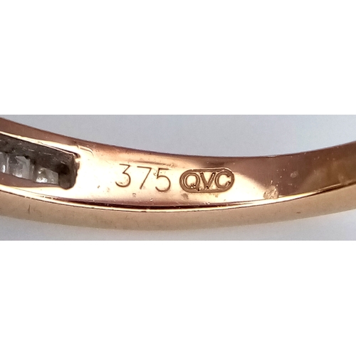 764 - A 9K Yellow Gold Diamond Half Eternity Ring. Tapered baguette channel set diamonds. Size L. 1.75g.