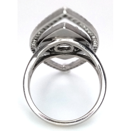 99 - An Art Deco Style Diamond and Sapphire Ring set in 18K White Gold. A 1.5ct round brilliant cut centr... 