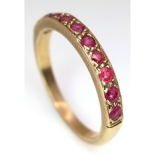 106 - A 9K Yellow Gold, Garnet Half Eternity Ring. Size N 1/2. 2.25g.