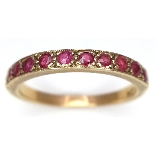 106 - A 9K Yellow Gold, Garnet Half Eternity Ring. Size N 1/2. 2.25g.