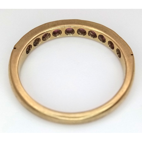 106 - A 9K Yellow Gold, Garnet Half Eternity Ring. Size N 1/2. 2.25g.