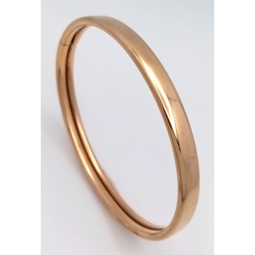 157 - A 9K Yellow Gold (tests as) Bangle. 7mm width. 60mm interior diameter. 6.83g.