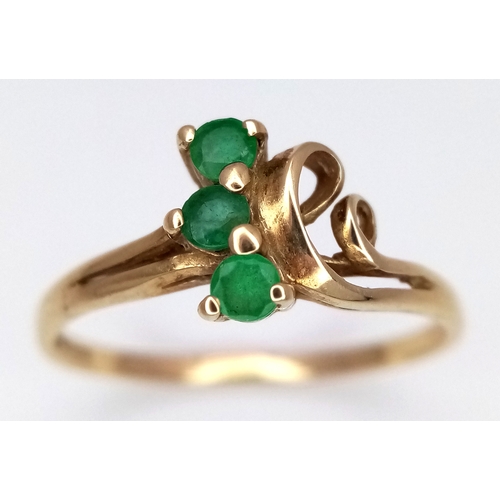 169 - A 9K Yellow Gold Three Stone Emerald Ring. Size M. 1.2g.