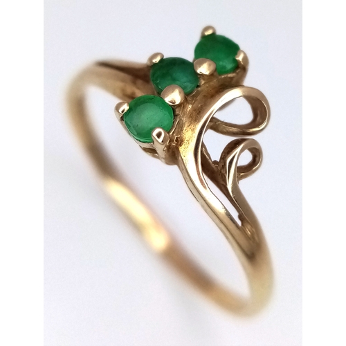 169 - A 9K Yellow Gold Three Stone Emerald Ring. Size M. 1.2g.