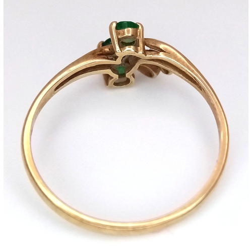169 - A 9K Yellow Gold Three Stone Emerald Ring. Size M. 1.2g.