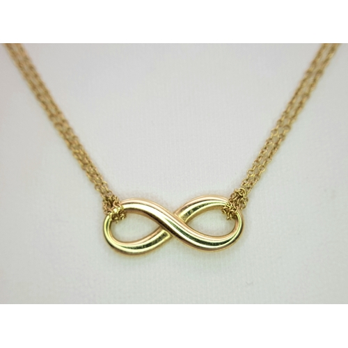 110 - A Tiffany and Co 18k yellow gold infinity necklace, 4.5g total weight, 16” chain length in original ... 