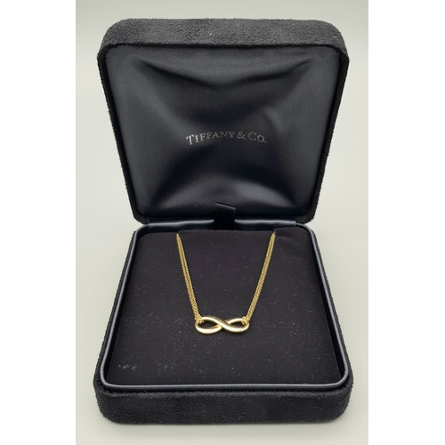 110 - A Tiffany and Co 18k yellow gold infinity necklace, 4.5g total weight, 16” chain length in original ... 