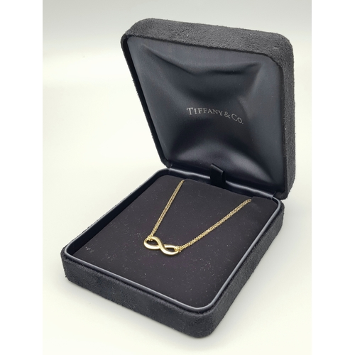 110 - A Tiffany and Co 18k yellow gold infinity necklace, 4.5g total weight, 16” chain length in original ... 