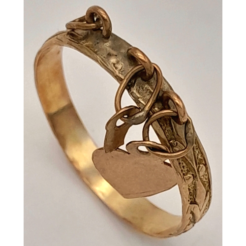 177 - A 9K Yellow Gold Band Ring with Hanging Heart charm. Size N. 1.45g