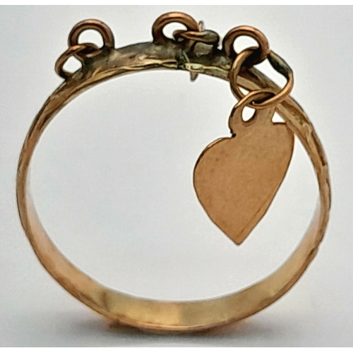 177 - A 9K Yellow Gold Band Ring with Hanging Heart charm. Size N. 1.45g