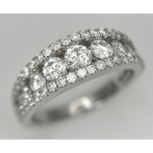 100 - An 18K White Gold Diamond Fancy Half-Eternity Ring. c. 1.1ctw of brilliant round cut graduating diam... 