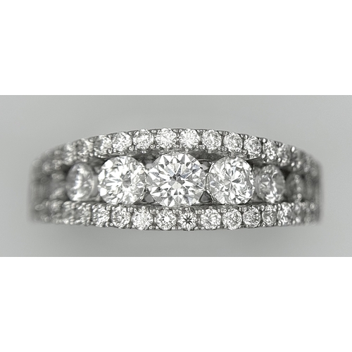 100 - An 18K White Gold Diamond Fancy Half-Eternity Ring. c. 1.1ctw of brilliant round cut graduating diam... 