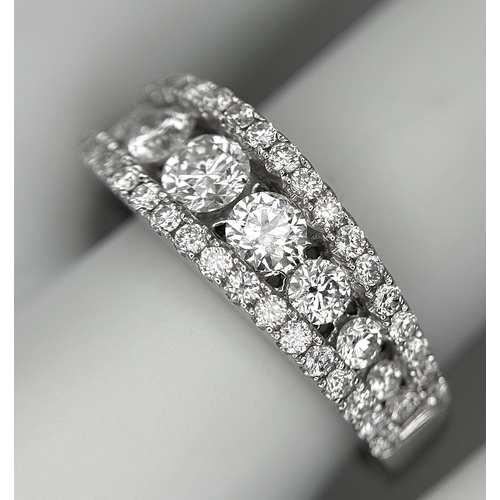 100 - An 18K White Gold Diamond Fancy Half-Eternity Ring. c. 1.1ctw of brilliant round cut graduating diam... 