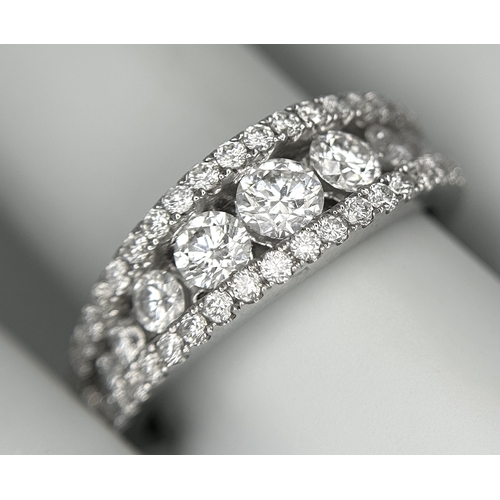 100 - An 18K White Gold Diamond Fancy Half-Eternity Ring. c. 1.1ctw of brilliant round cut graduating diam... 
