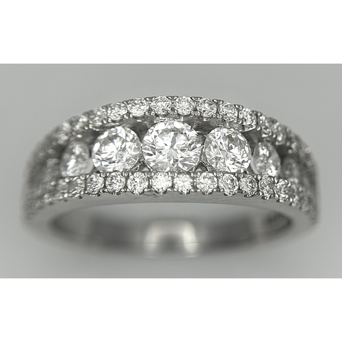 100 - An 18K White Gold Diamond Fancy Half-Eternity Ring. c. 1.1ctw of brilliant round cut graduating diam... 