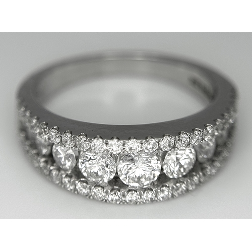 100 - An 18K White Gold Diamond Fancy Half-Eternity Ring. c. 1.1ctw of brilliant round cut graduating diam... 