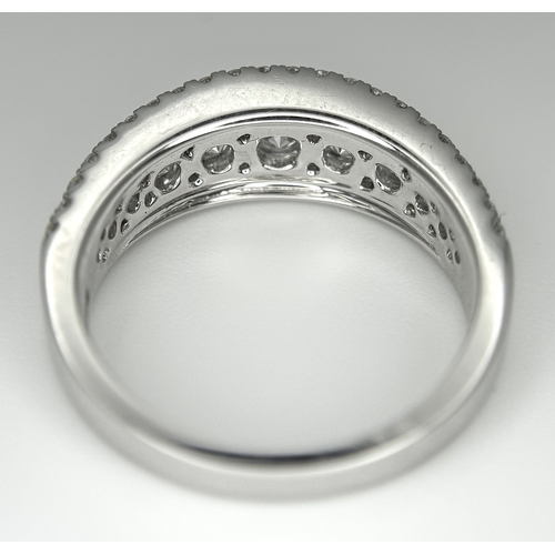 100 - An 18K White Gold Diamond Fancy Half-Eternity Ring. c. 1.1ctw of brilliant round cut graduating diam... 