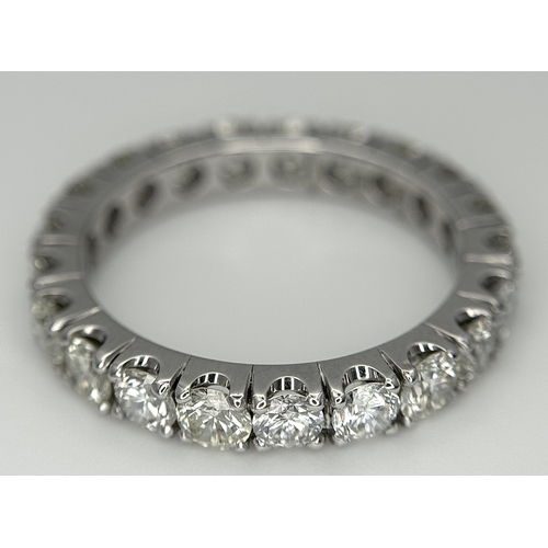 128 - A 950 Platinum Diamond Eternity Ring. 21 round brilliant cut diamonds - 3.25ctw. VS1/2 clarity. G-H ... 
