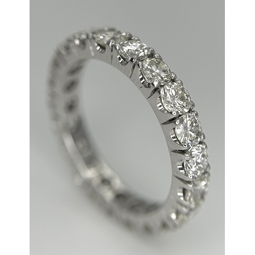 128 - A 950 Platinum Diamond Eternity Ring. 21 round brilliant cut diamonds - 3.25ctw. VS1/2 clarity. G-H ... 
