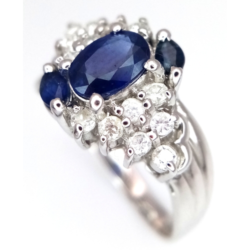 142 - An 18K White Gold, Diamond and Sapphire Ring. c. 1ct of high grade sapphires with a c. 0.5ctw diamon... 
