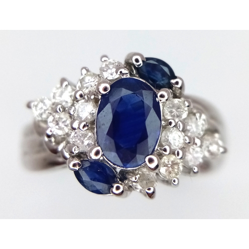 142 - An 18K White Gold, Diamond and Sapphire Ring. c. 1ct of high grade sapphires with a c. 0.5ctw diamon... 