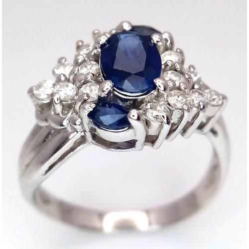 142 - An 18K White Gold, Diamond and Sapphire Ring. c. 1ct of high grade sapphires with a c. 0.5ctw diamon... 
