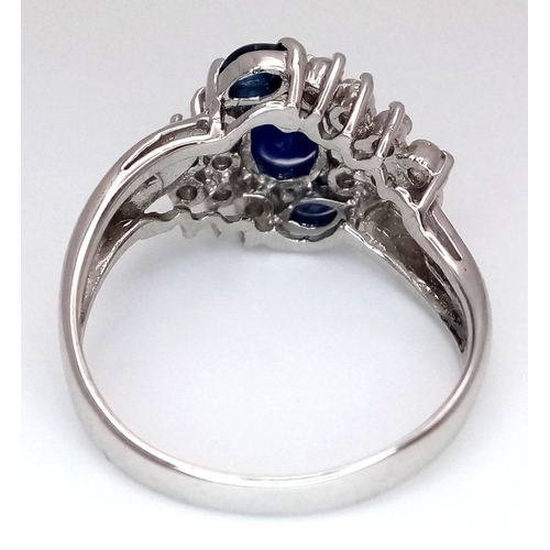 142 - An 18K White Gold, Diamond and Sapphire Ring. c. 1ct of high grade sapphires with a c. 0.5ctw diamon... 