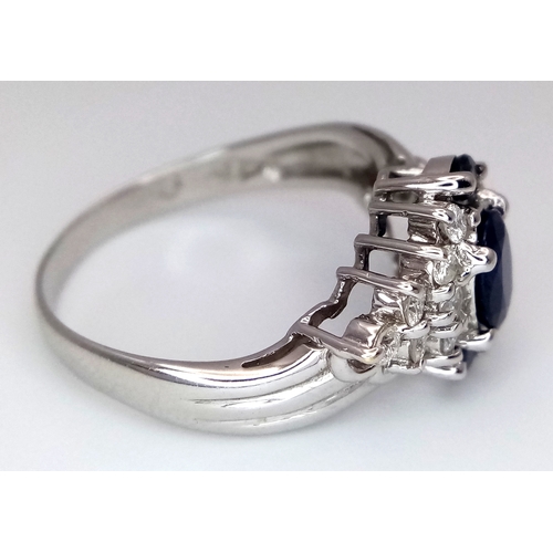 142 - An 18K White Gold, Diamond and Sapphire Ring. c. 1ct of high grade sapphires with a c. 0.5ctw diamon... 
