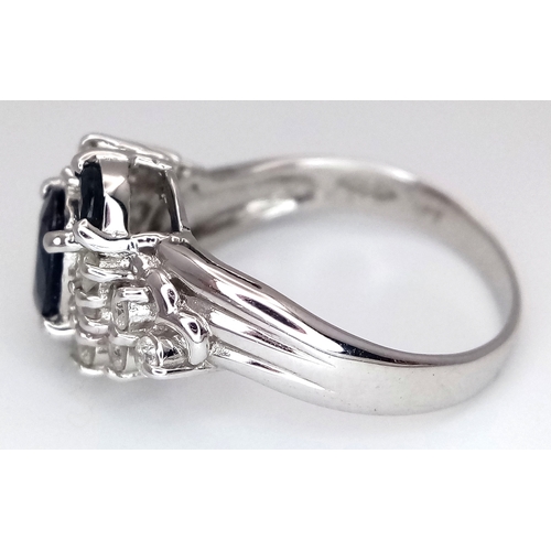 142 - An 18K White Gold, Diamond and Sapphire Ring. c. 1ct of high grade sapphires with a c. 0.5ctw diamon... 