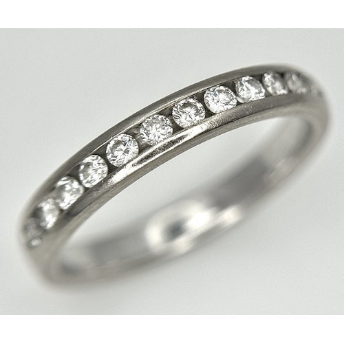 75 - AN 18K WHITE GOLD DIAMOND SET HALF ETERNITY RING. 0.25CTW. 3.5G. SIZE M. SC4075.