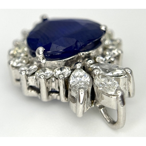 107 - An 18K White Gold, Sapphire and Diamond Pendant. A c. 2ct Madagascan heart-shaped blue sapphire with... 
