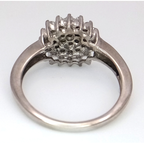 125 - A 9K WHITE GOLD DIAMOND SET CLUSTER RING. 0.25CTW. 3.9G. SIZE O. SC4034.