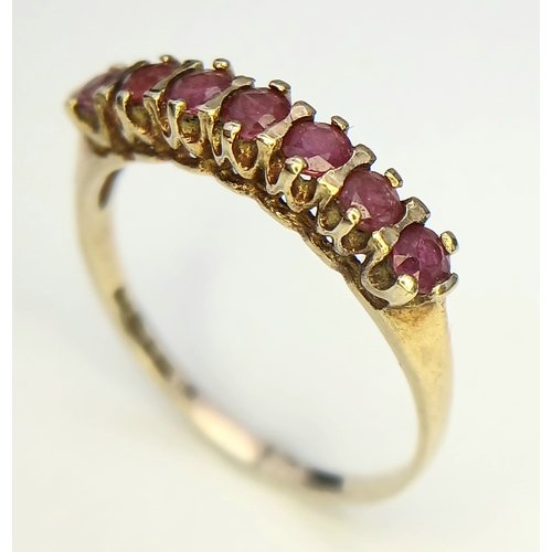 154 - Extremely Pretty 9 CARAT GOLD and RUBY RING,  SET WITH a SWEEP of 7 RUBIES . Full UK hallmark.1.6 Gr... 