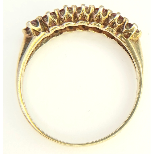 154 - Extremely Pretty 9 CARAT GOLD and RUBY RING,  SET WITH a SWEEP of 7 RUBIES . Full UK hallmark.1.6 Gr... 