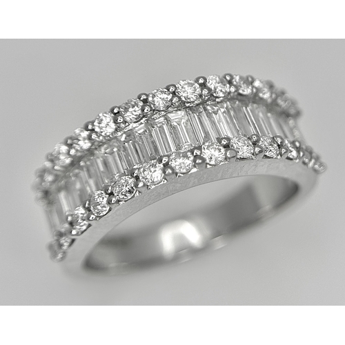 179 - An 18K White Gold Diamond Half Eternity Ring. c. 2.5ctw of baguette and round brilliant cut diamonds... 