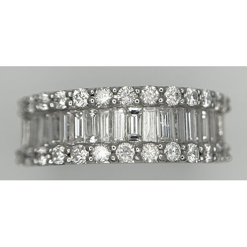 179 - An 18K White Gold Diamond Half Eternity Ring. c. 2.5ctw of baguette and round brilliant cut diamonds... 