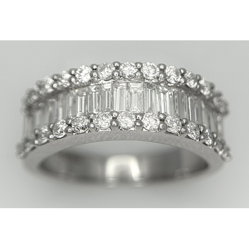 179 - An 18K White Gold Diamond Half Eternity Ring. c. 2.5ctw of baguette and round brilliant cut diamonds... 