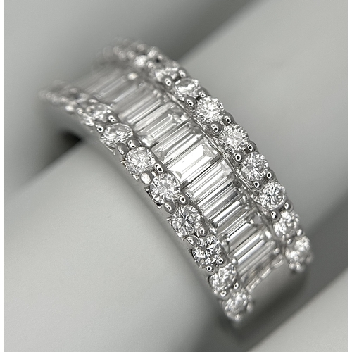 179 - An 18K White Gold Diamond Half Eternity Ring. c. 2.5ctw of baguette and round brilliant cut diamonds... 