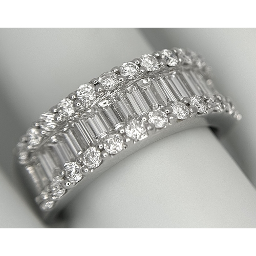179 - An 18K White Gold Diamond Half Eternity Ring. c. 2.5ctw of baguette and round brilliant cut diamonds... 